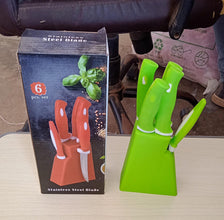 Complete stainless steel kitchen knife and peeler set with stand.